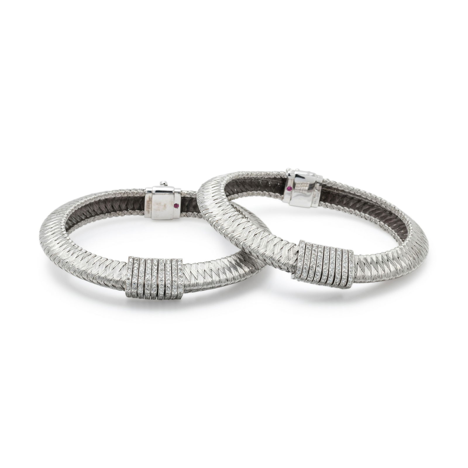 ROBERTO COIN, PAIR OF WHITE GOLD AND DIAMOND BRACELETS: ROBERTO COIN, PAIR OF WHITE GOLD AND DIAMOND BRACELETS Consisting of two bracelets in a triangular shaped woven design containing numerous round brilliant cut diamonds weighing approximately 2.70 cara