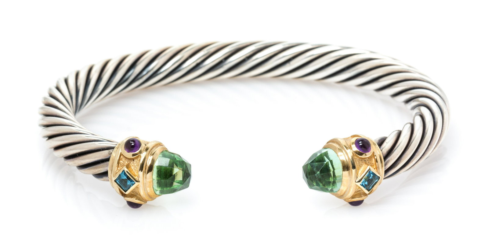 STERLING SILVER, YELLOW GOLD AND GEMSTONE 'RENAISSANCE': STERLING SILVER, YELLOW GOLD AND GEMSTONE 'RENAISSANCE' CUFF BRACELET Consisting of a cable measuring approximately 7.00 mm wide, the gold finials containing two rose cut prasiolites, two square step 
