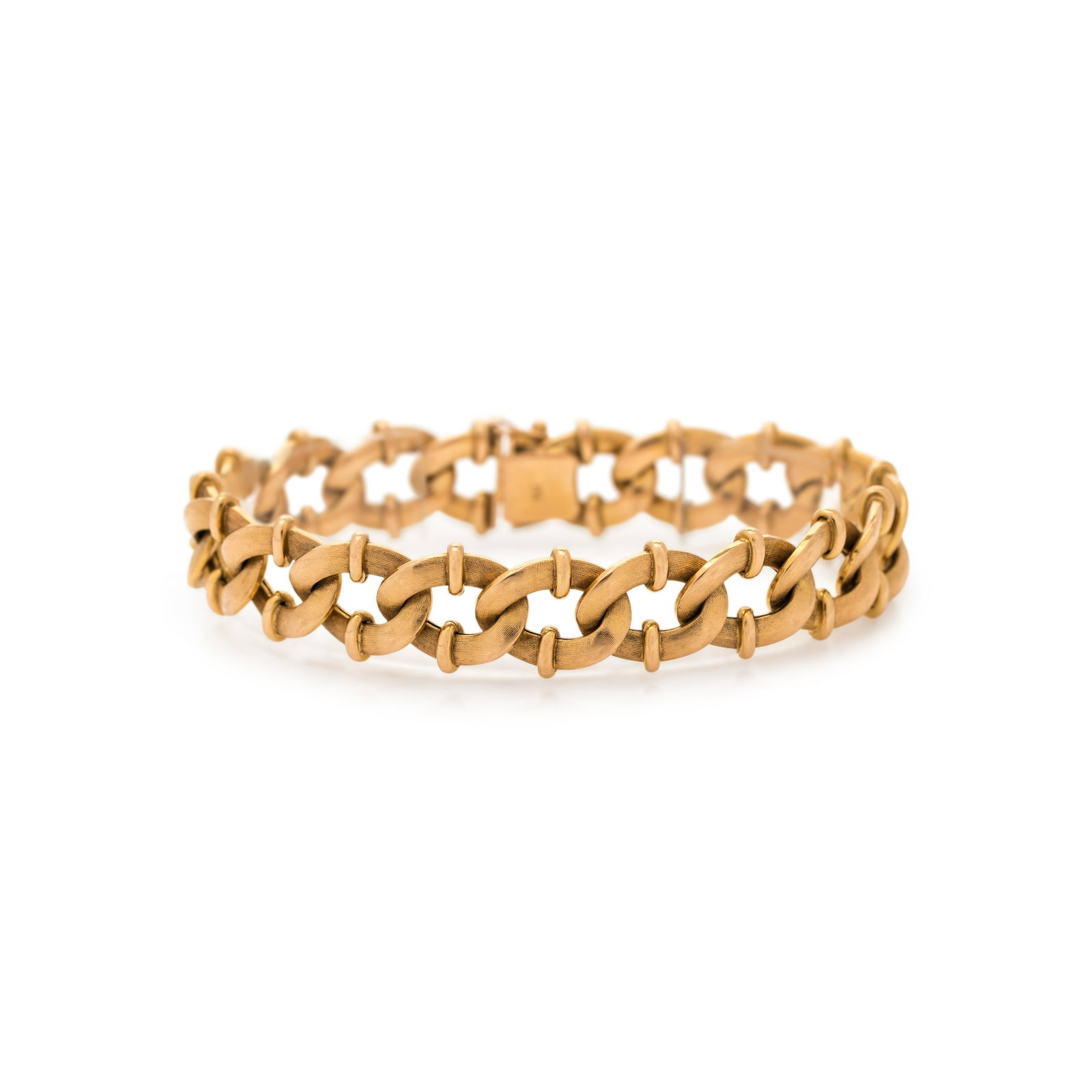 YELLOW GOLD BRACELET: YELLOW GOLD BRACELET Consisting of a textured curb link chain with oval link details measuring approximately 15.00 mm wide. Stamp: 750 (partially obscured maker's mark). 21.10 dwt.