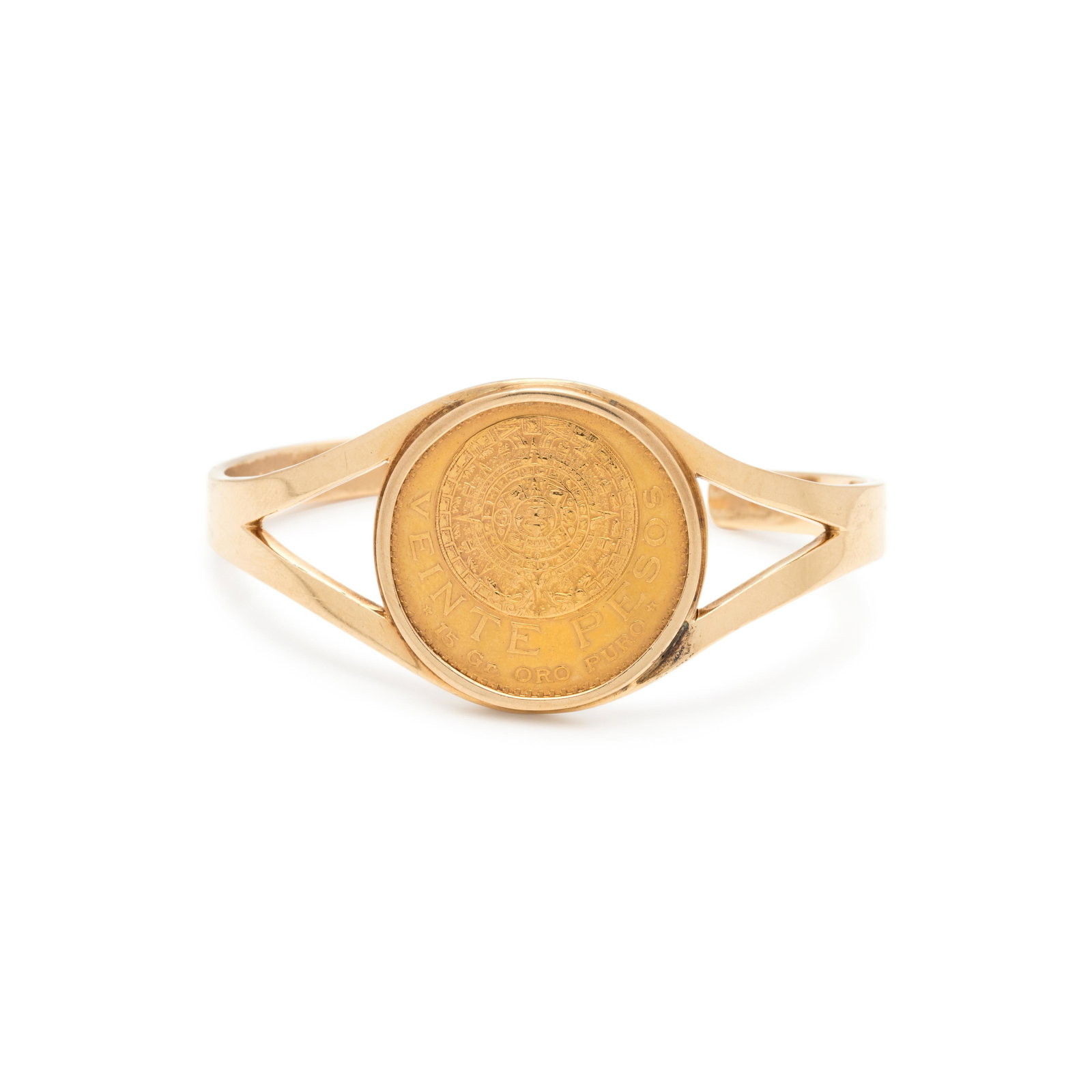 YELLOW GOLD AND MEXICAN 20 PESOS COIN CUFF BRACELET: YELLOW GOLD AND MEXICAN 20 PESOS COIN CUFF BRACELET Containing one Mexican Aztec Calendar 20 pesos coin, dated 1918. Stamp: (maker's mark) 14K. 23.85 dwt.