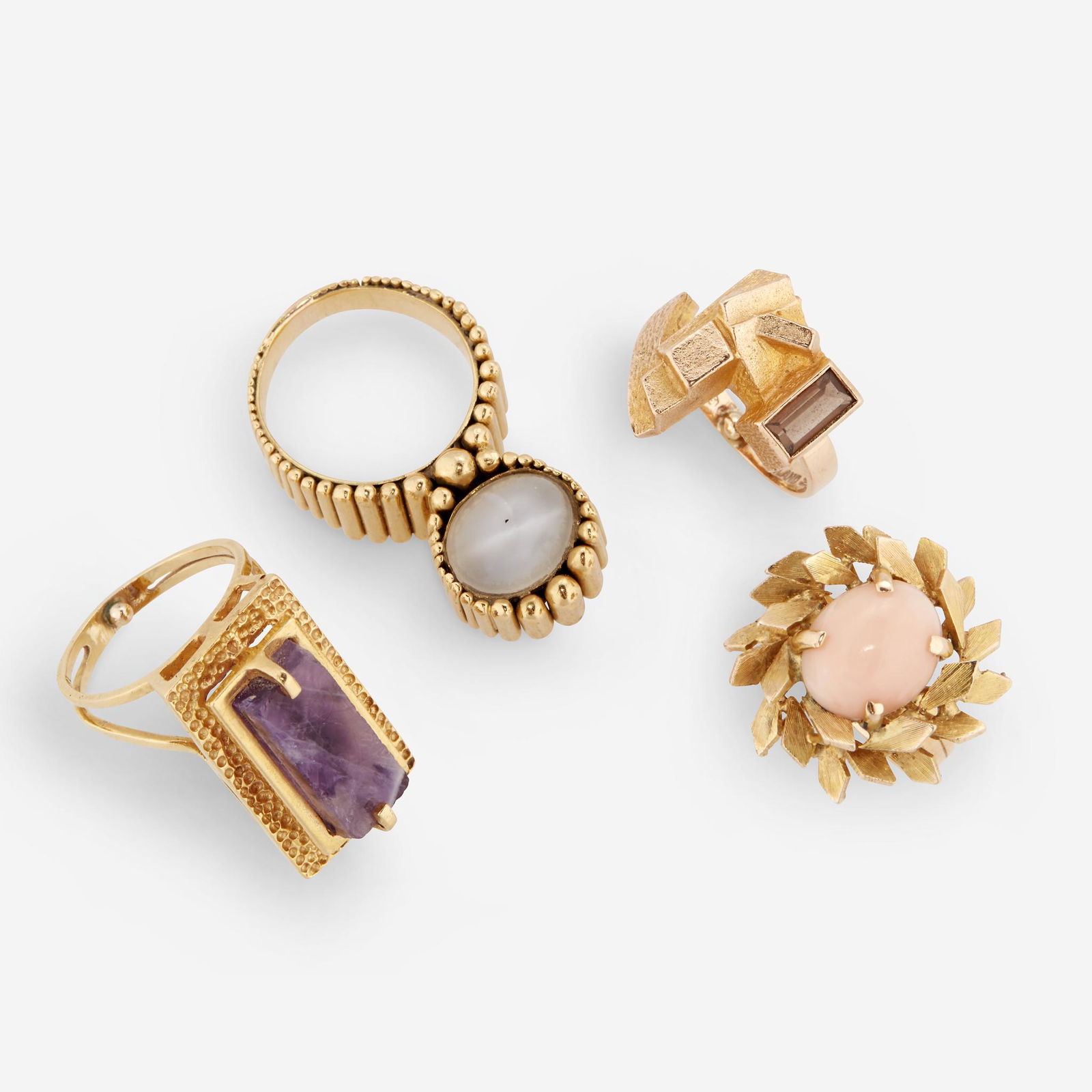 A group of four Modernist gem-set rings, including Ed: A group of four Modernist gem-set rings, including Ed Wiener including a step-cut smoky quartz and fourteen karat gold ring by Ed Wiener; an oval cat's eye moonstone cabochon and fourteen karat ring;