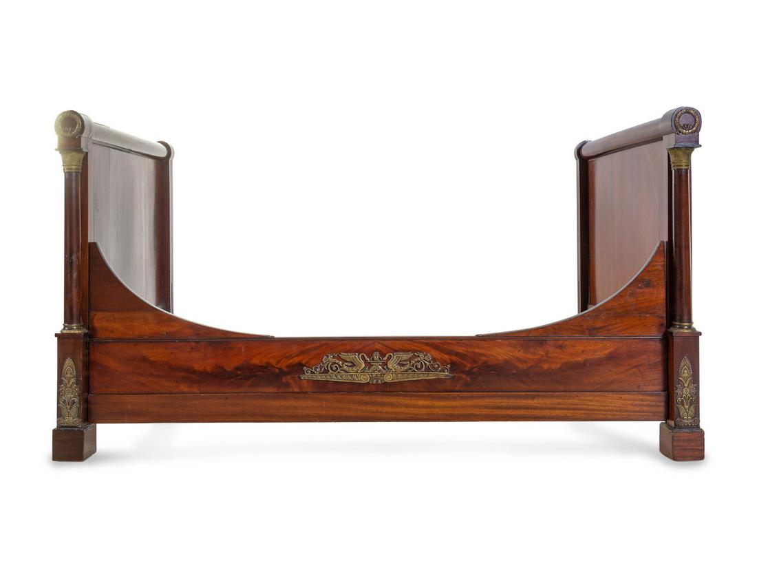 An Empire Style Gilt Metal Mounted Mahogany Bed: An Empire Style Gilt Metal Mounted Mahogany Bed Late 19th Century Height 42 x width 74 x depth 45 1/2 inches.