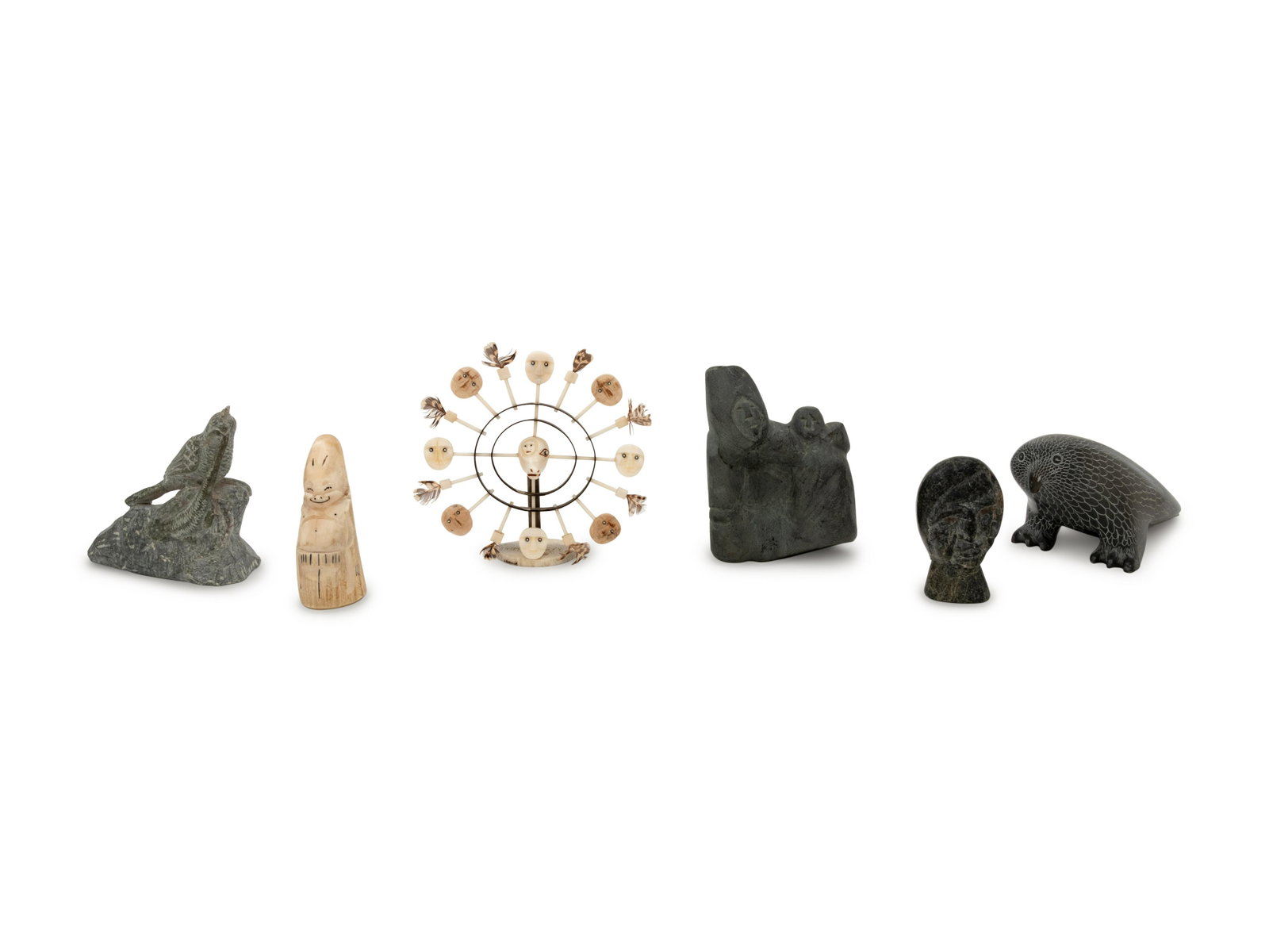 A Collection of Inuit Carved Stone and Bone Sculptures: A Collection of Inuit Carved Stone and Bone Sculptures Second Half 20th Century comprising a Nunivak maskette signed J. Kokuluk, a billiken, a carved head, a figural group and two bird carvings. He