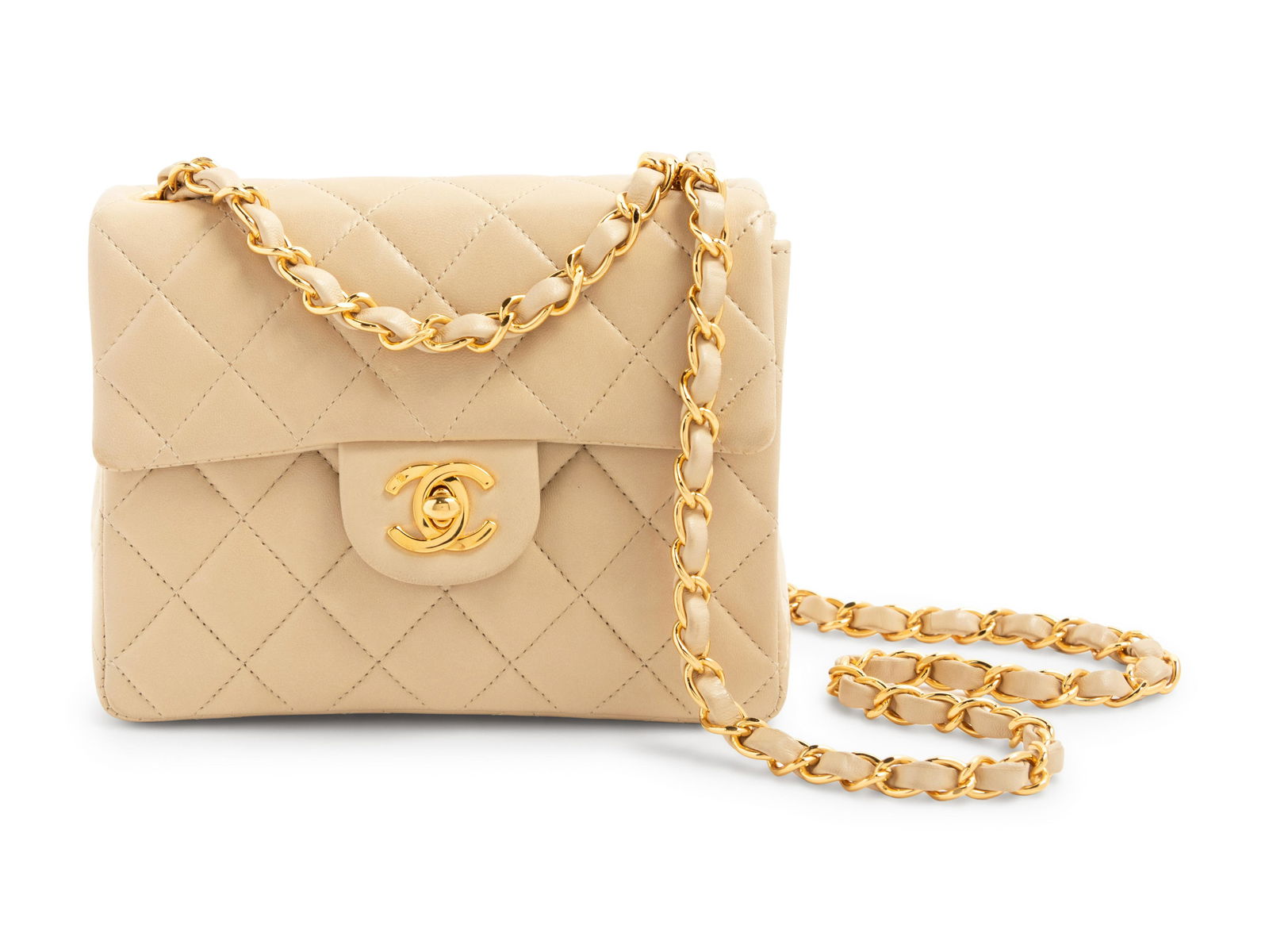 Chanel Beige Classic Quilted Leather Flap Bag, 1997-99: Chanel Beige Classic Quilted Leather Flap Bag, 1997-99 Beige quilted leather flap bag with gold-tone CC twist lock closure and Mademoiselle chain strap. Comes with a box. Label (stamped): Chanel Seria