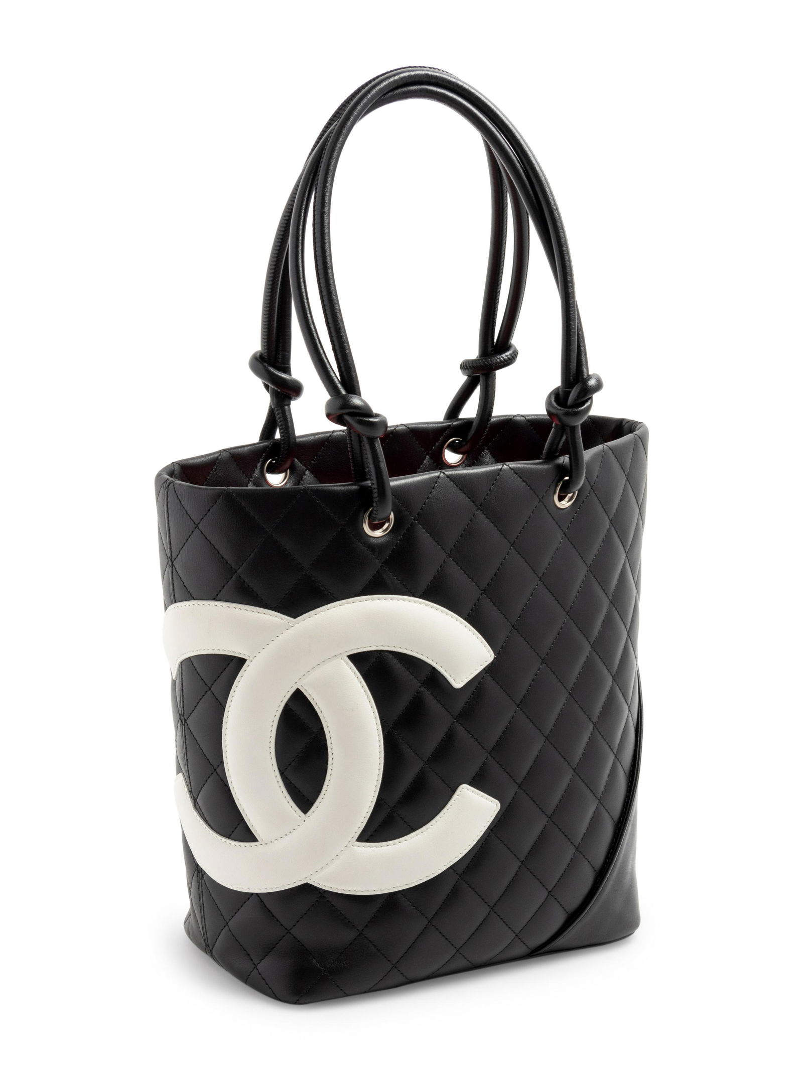Chanel Cambon Ligne Tote, 2004-05: Chanel Cambon Ligne Tote, 2004-05 Black quilted leather tote with large white lather CC logo and black leather straps. Bag is lined with CC woven pink fabric and closed with an inner zipper. The three