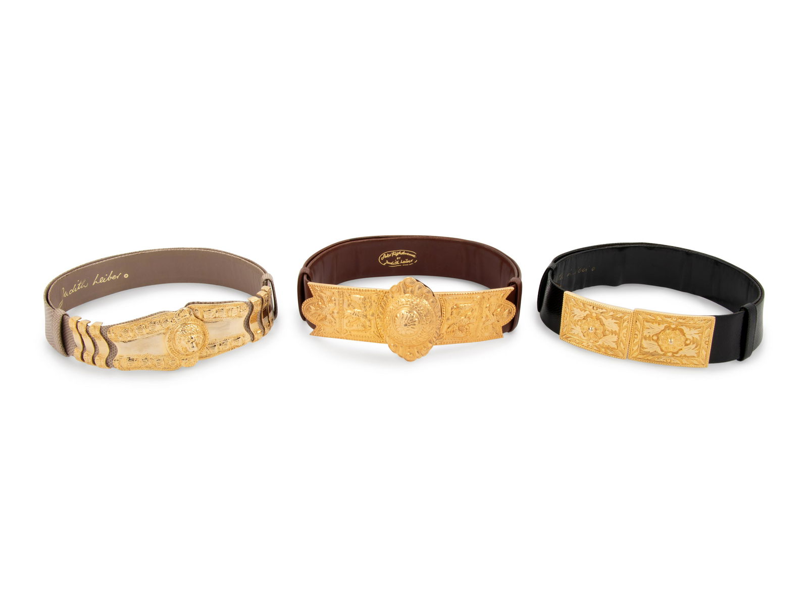 Four Judith Leiber Belts: Four Judith Leiber Belts This lot has four belts.† THE FIRST Taupe adjustable Karung snake skin belt with gold-tone lion headed buckle.† Label (stamped): Judith Leiber † Approximate
