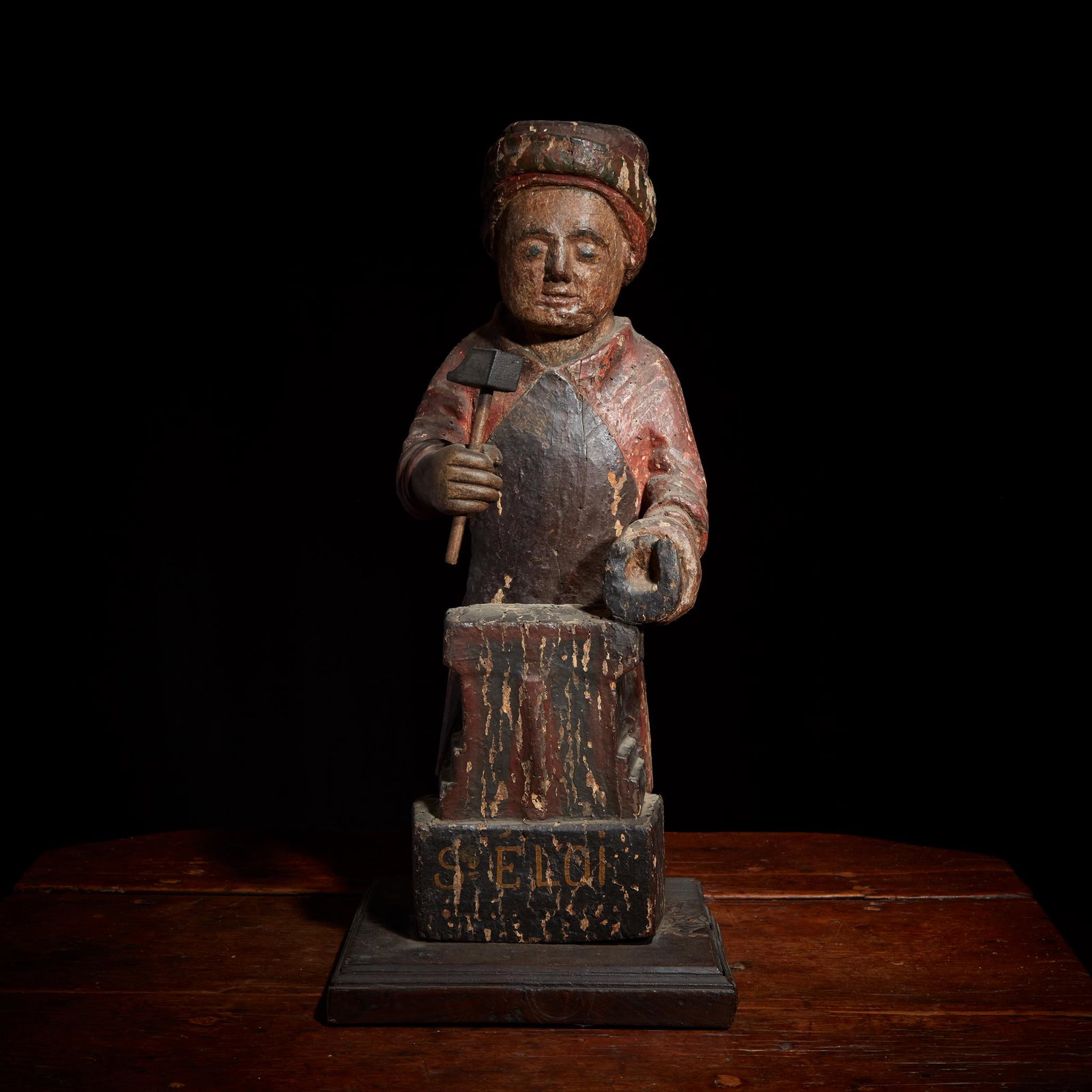 A French polychromed figure of Saint Eligius (Eloi): A French polychromed figure of Saint Eligius (Eloi) depicted as a farrierprobably 17th centuryThe hammer and base later replaced.H: 21 1/2 in. (approx.)PROVENANCE:The collection of Samuel Yellin (Amer