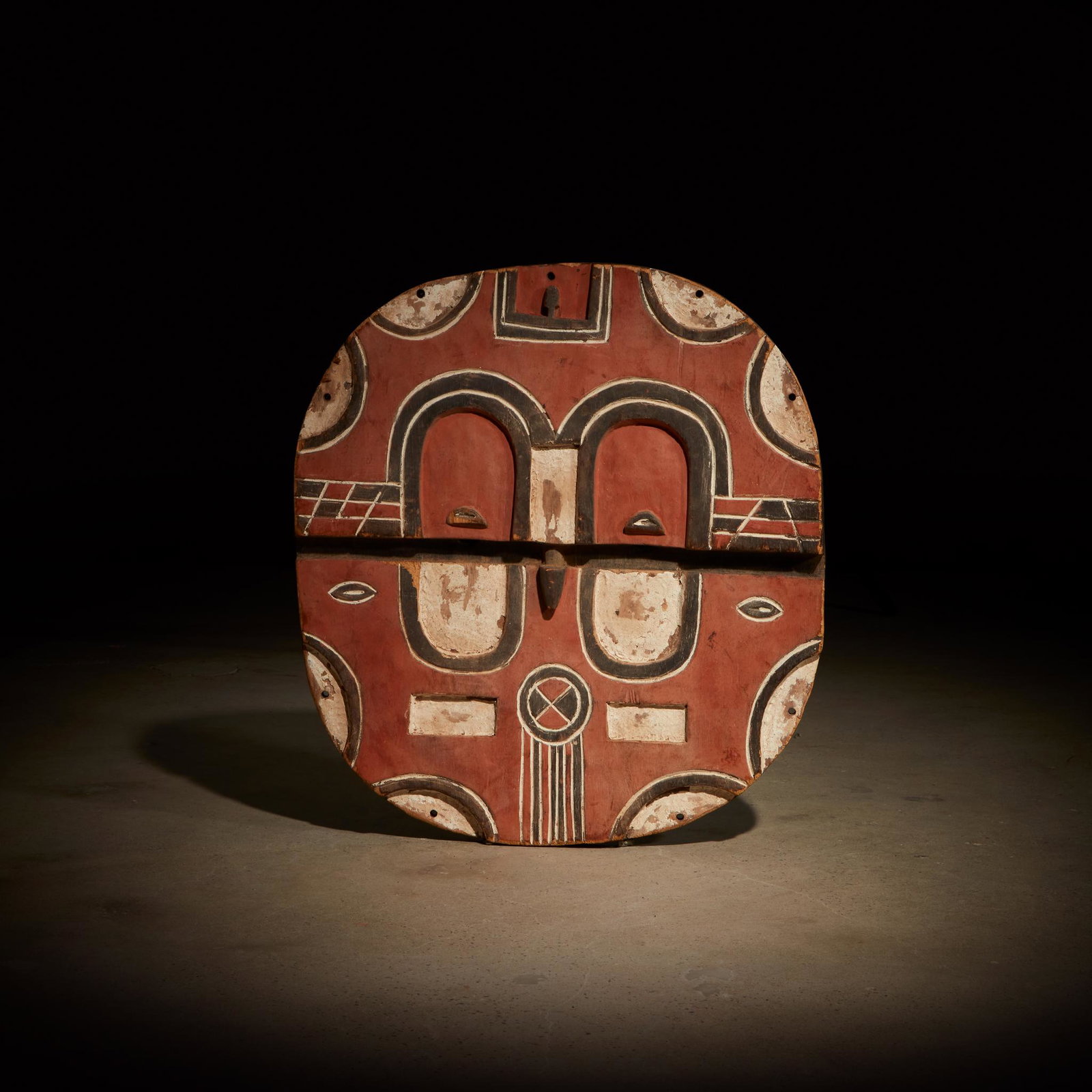 A Teke Tsaye mask, kidumu, Democratic Republic of Congo: A Teke Tsaye mask, kidumu Democratic Republic of Congo Carved wood and pigment, carved in high relief with a central recessed section, decorated with abstract incised motifs, accented with pigment and