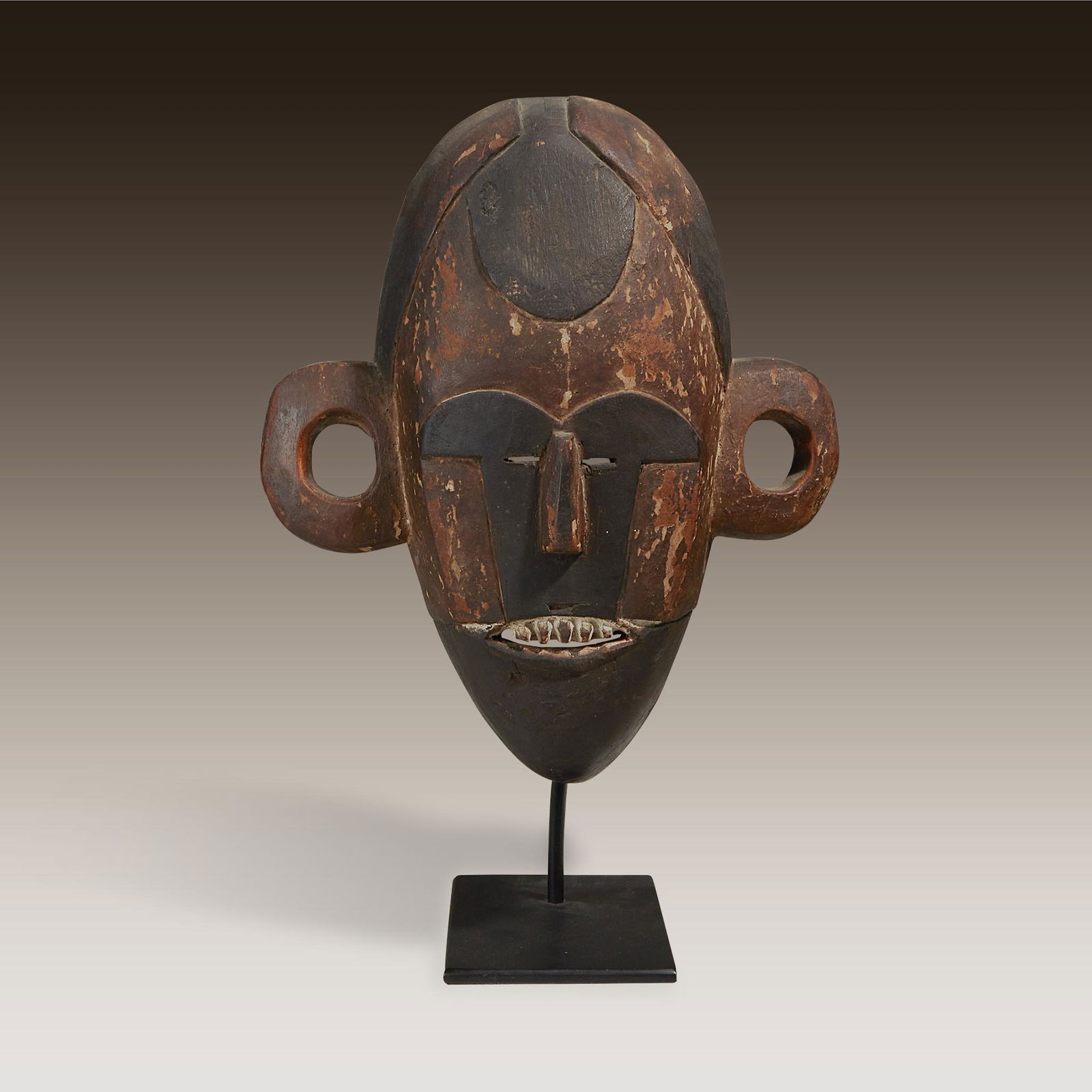 A Boa style mask, Democratic Republic of Congo: A Boa style mask Democratic Republic of Congo Carved wood and pigment, of oval form, the coiffure hanging over the forehead, the eyes placed centrally alongside the bridge of the nose, the mouth open