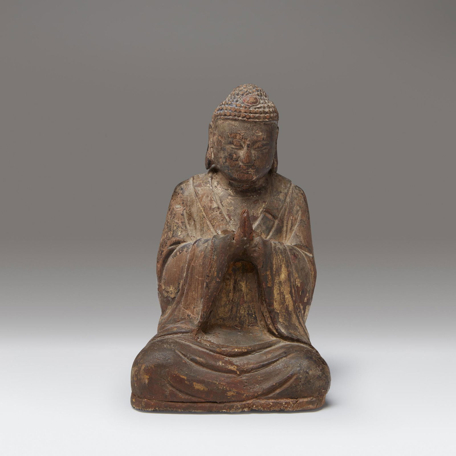 A small Chinese gilt lacquered wood figure of a seated (1 of 3)