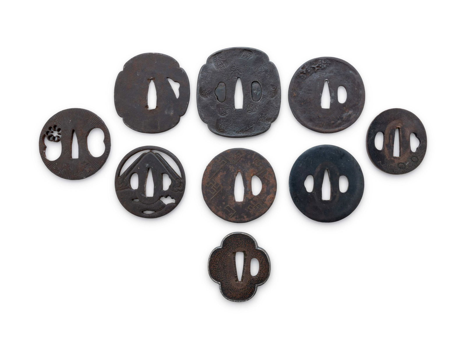 Nine Cast Iron Tsubas: Nine Cast Iron Tsubas of various forms, unsigned. Length 3 7/16 in., 8.7 cm. Property from the Estate of WM Bogdanowicz, Madison, Wisconsin and Naples, Florida