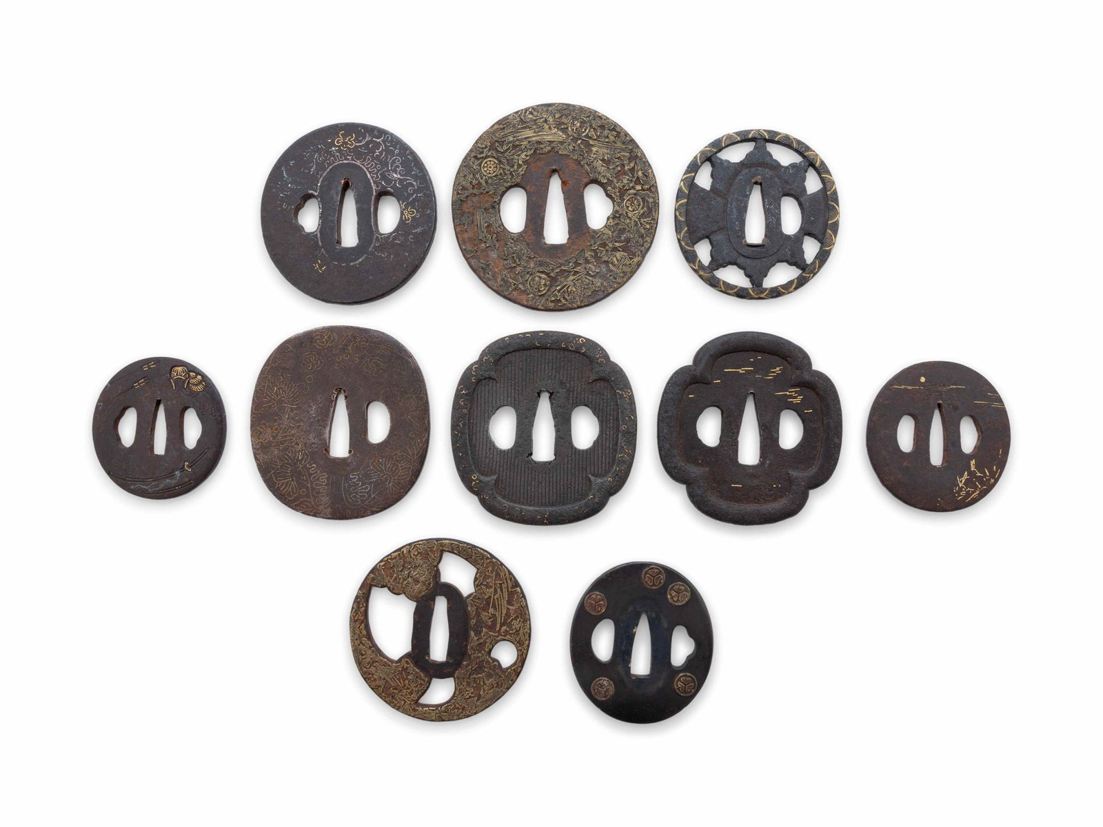 Ten Cast Iron Tsubas: Ten Cast Iron Tsubas of various forms, inlaid in gold or silver, unsigned. Diameter of largest 3 1/2 in., 8.9 cm. Property from the Estate of WM Bogdanowicz, Madison, Wisconsin and Naples, Florida
