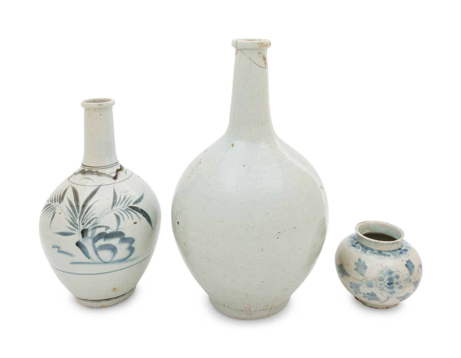 Three Korean Porcelain Bottle Vases: Three Korean Porcelain Bottle Vases comprising a large white glazed example, two a blue and white examples. Height of tallest 14 in., 35.56 cm. Property from the Estate of WM Bogdanowicz, Madison, Wis
