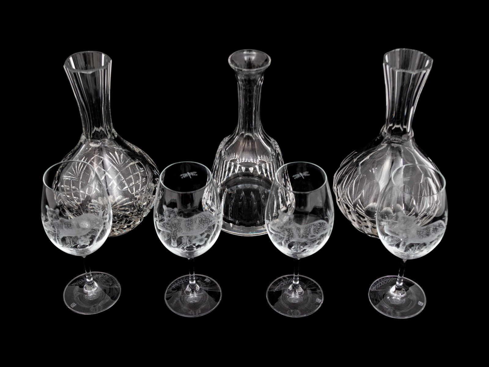 A Set of Four Lynn Chase Wine Glasses with Three: A Set of Four Lynn Chase Wine Glasses with Three Decanters Height of tallest decanter 10 inches. Property from the Estate of Sally Gatling Tomlinson, Atlanta, Georgia