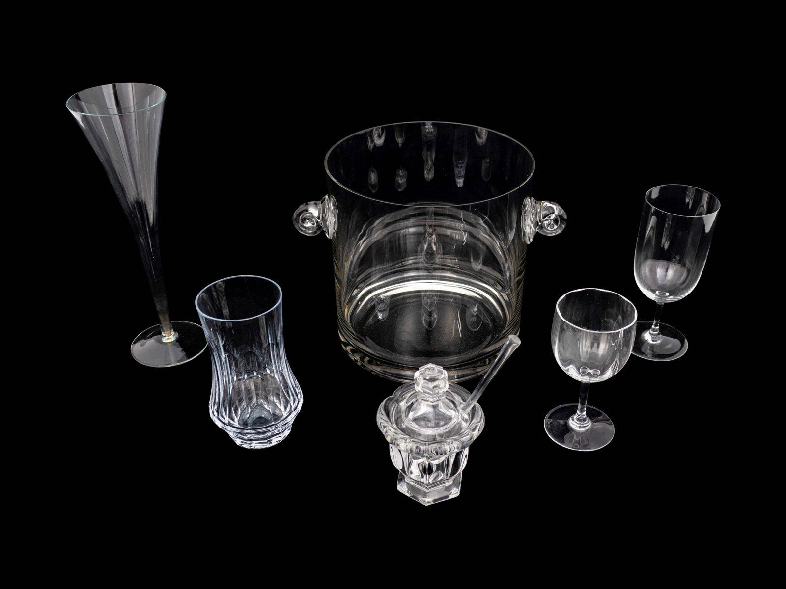 Assembled Glass Bar Items Height of tallest 10 inches.: Assembled Glass Bar Items comprising: 8 tumblers 7 champagne flutes 7 Baccarat wine glasses 4 small Baccarat wine glasses 1 Baccarat sugar bowl with spoon 1 ice bucket (28 pieces) Height of tallest 10