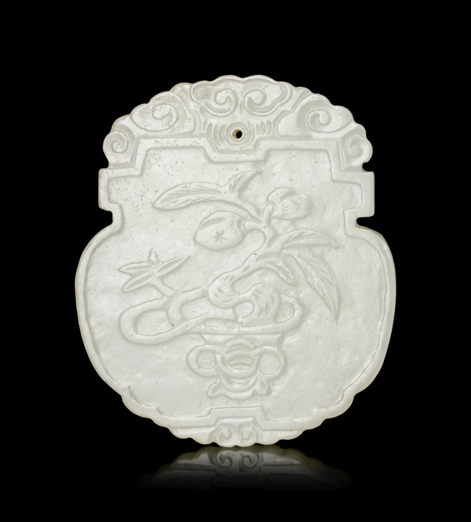 A Chinese White Jade Pendant: A Chinese White Jade Pendant carved in low relief to the front side with a flower basket, the back side with a seal mark, the stone of an even tone with natural inclusions. Height 2 1/8 in., 5.4 cm.