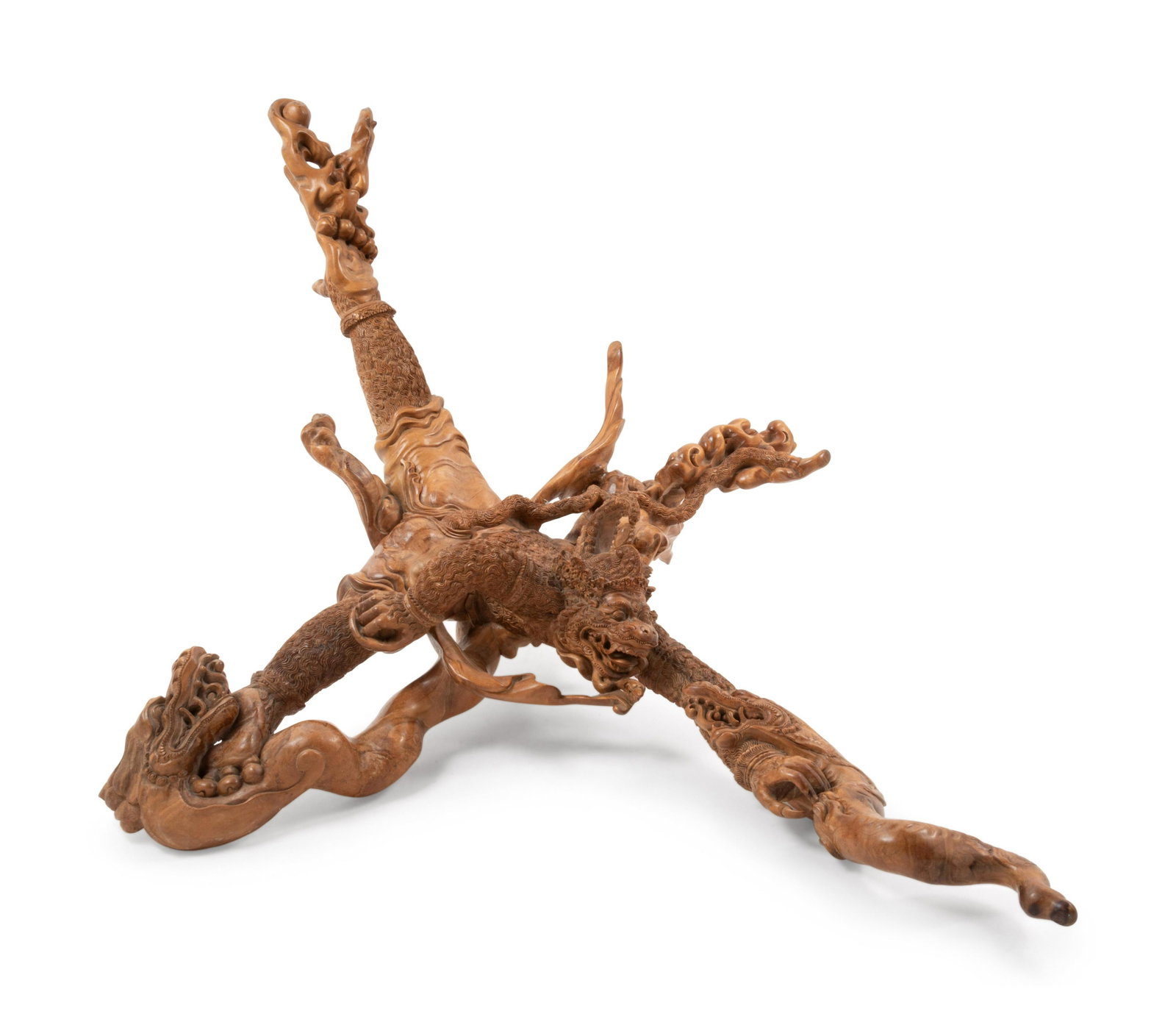 A Burmese Hardwood Carving: A Burmese Hardwood Carving carved as a mythical beast crawling on branches. Length 41 in., 104.14 cm. Property from a Private Chicago Estate