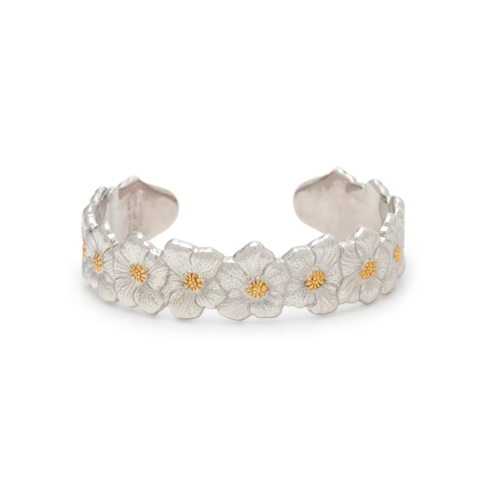BUCCELLATI, STERLING SILVER AND YELLOW GOLD 'BLOSSOMS': BUCCELLATI, STERLING SILVER AND YELLOW GOLD 'BLOSSOMS' CUFF BRACELET Consisting of textured silver flowers with yellow gold detail, measuring approximately 15.00 mm wide. Stamp: BUCCELLATI ITALY (make
