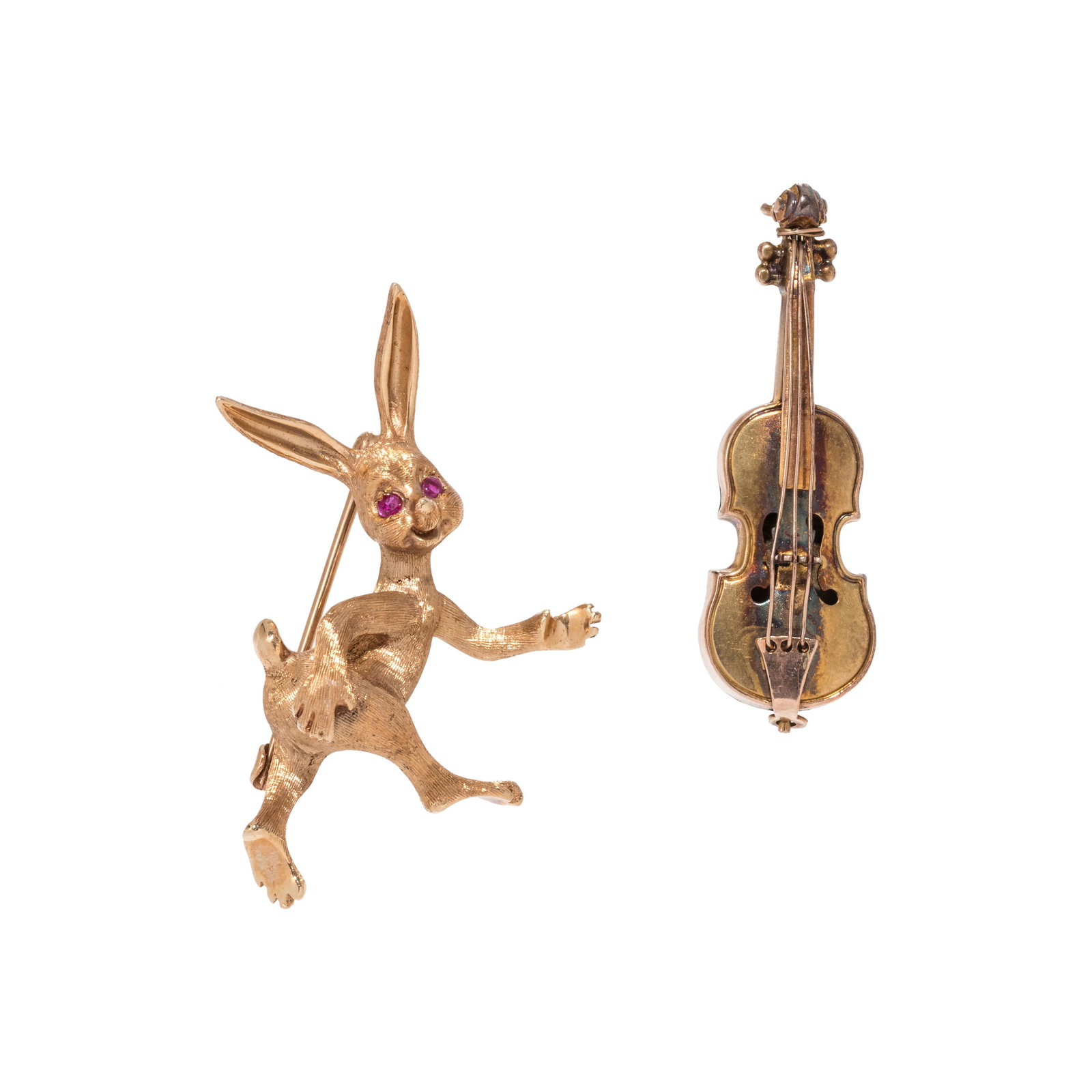 COLLECTION OF GOLD BROOCHES: COLLECTION OF GOLD BROOCHES Consisting of a textured yellow gold rabbit brooch with two ruby eyes, together with a British violin brooch. Rabbit brooch stamp: (partially obscured). Rabbit brooch pin b