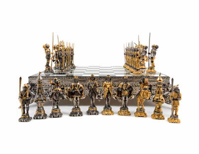 A Giuseppe Vasari Gilt and Silvered Bronze Medieval: A Giuseppe Vasari Gilt and Silvered Bronze Medieval Chess Set (Italian, 1934-2005) the game board in alternating blue onyx and white marble squares, raised on a silvered bronze base. Height of board 3