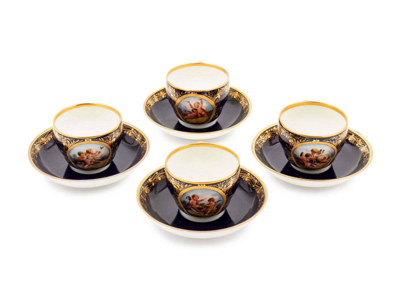 A Set of Four Berlin (K.P.M.) Parcel Gilt Cobalt Ground: A Set of Four Berlin (K.P.M.) Parcel Gilt Cobalt Ground Porcelain Teacups and Saucers 19th Century Height of each 2 1/8 x diameter 5 inches. Property from the Estate of a Midwest Collector, Milwaukee,