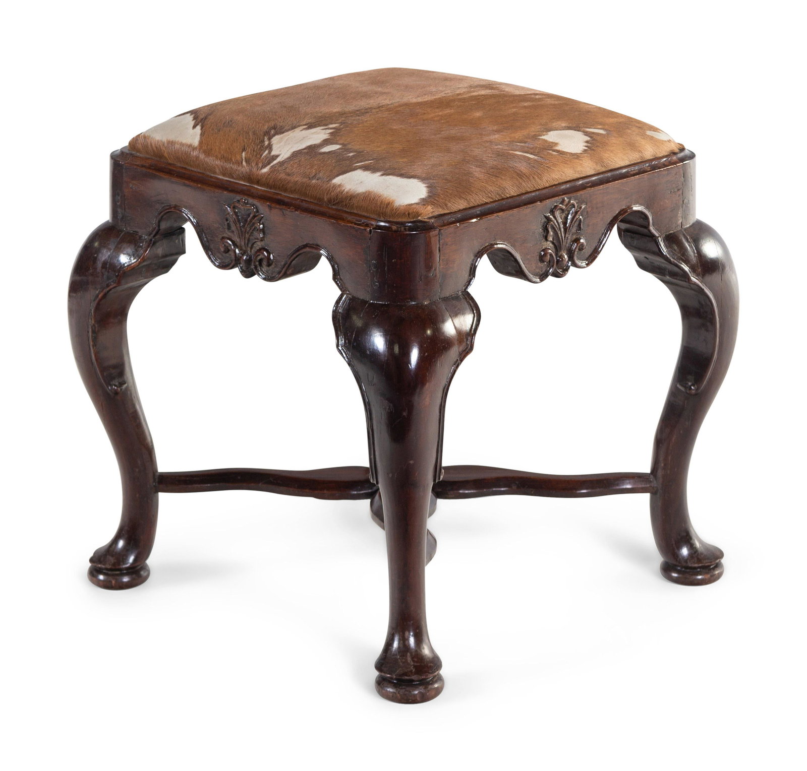 A George II Carved Walnut Footstool with Cowhide: A George II Carved Walnut Footstool with Cowhide Upholstery 18th Century Height 20 x width 20 x depth 19 1/2 inches. Property from a Robert Metzger-designed interior, Maryland