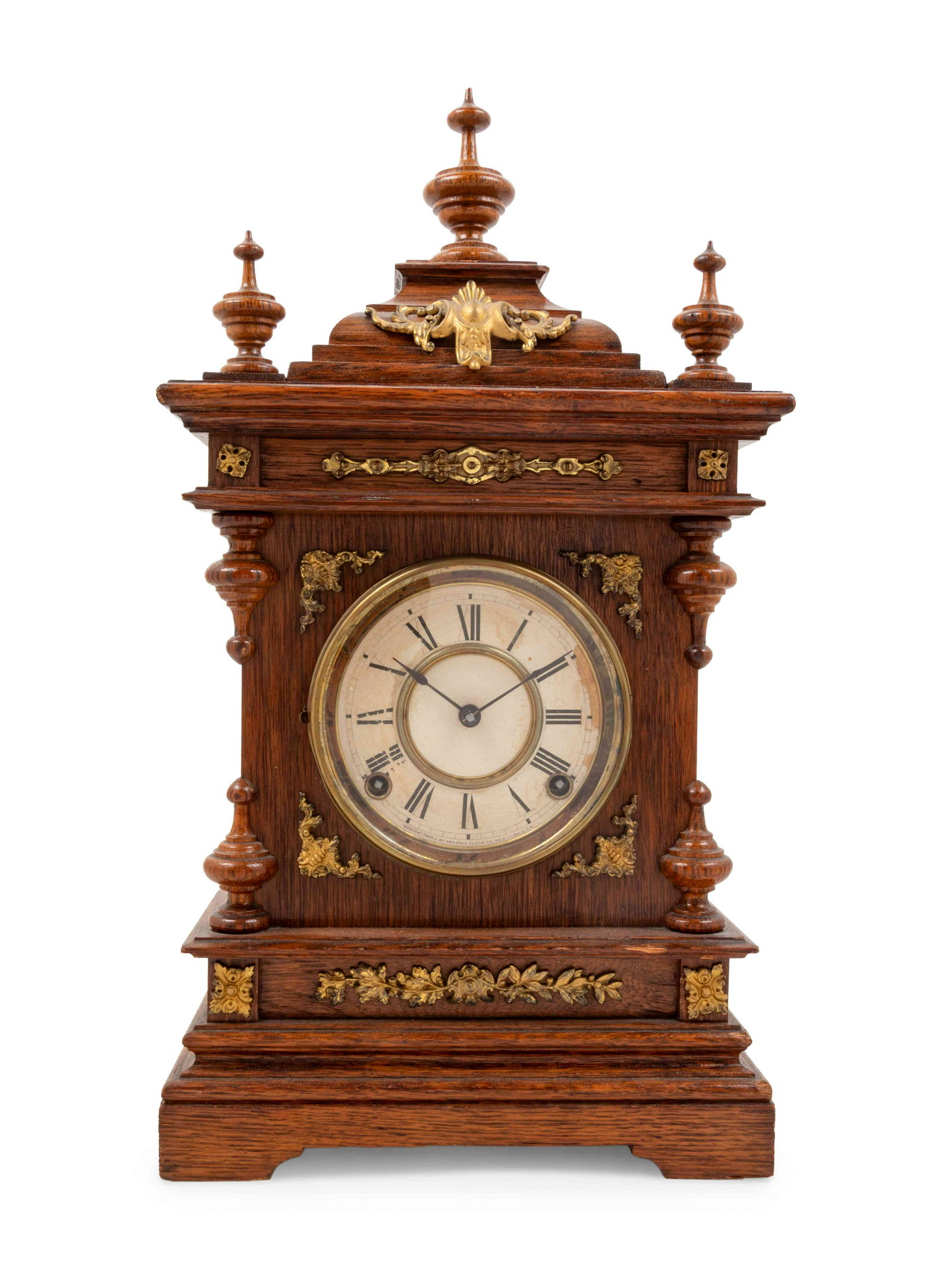 An Ansonia Cabinet A Brass Mounted Oak Shelf Clock: An Ansonia Cabinet A Brass Mounted Oak Shelf Clock Height 19 1/2 x width 10 1/4 x depth 4 3/4 inches. Property from the Collection of a Wisconsin Museum
