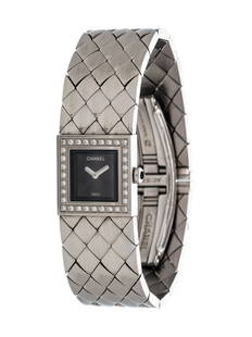 CHANEL, STEEL AND DIAMOND 'MATELASSE' WRISTWATCH: CHANEL, STEEL AND DIAMOND 'MATELASSE' WRISTWATCH 19.00 x 19.00 mm case dimensions, the bezel containing 32 round brilliant cut diamonds, quilted motif black dial, quartz movement, flexible link