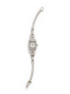 HAMILTON, PLATINUM AND DIAMOND WRISTWATCH: HAMILTON, PLATINUM AND DIAMOND WRISTWATCH The bezel, lugs and bracelet containing two triangular cut diamonds weighing approximately 1.50 carats total, 20 baguette cut diamonds weighing approximately