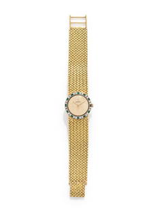CORUM, 18K YELLOW GOLD, DIAMOND AND EMERALD WRISTWATCH: CORUM, 18K YELLOW GOLD, DIAMOND AND EMERALD WRISTWATCH 23.00 mm case diameter, the bezel containing 24 round brilliant cut diamonds and 12 round mixed cut emeralds, matte gold dial, manual wind 17