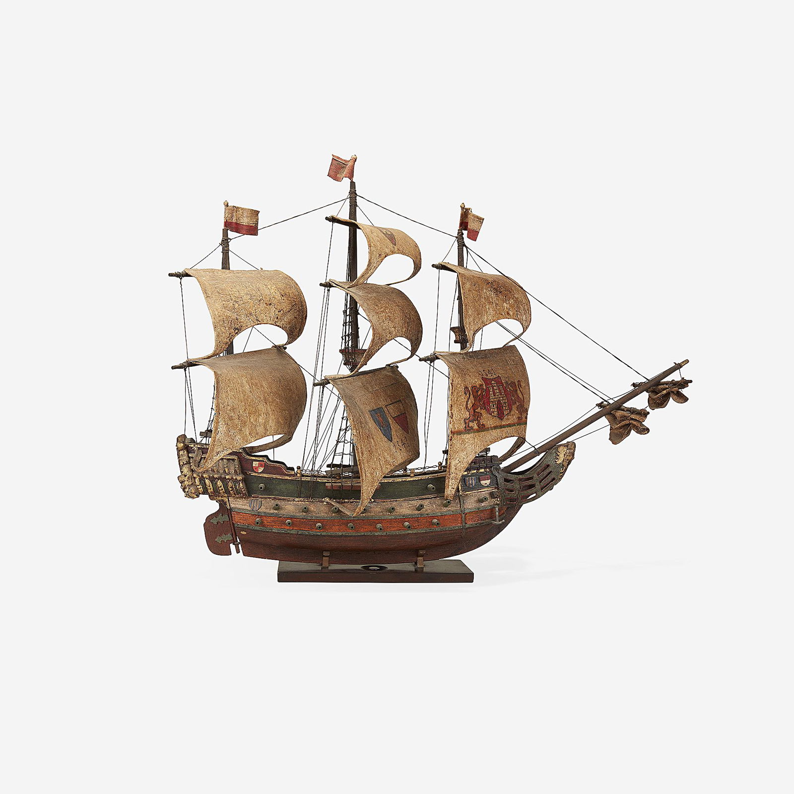 A parcel-gilt and polychromed carved wood model of a: A parcel-gilt and polychromed carved wood model of a Spanish galleon probably 19th centuryCarved wood, rope rigging, and plastered canvas sails, the sails decorated with the Arms of Castile and dated