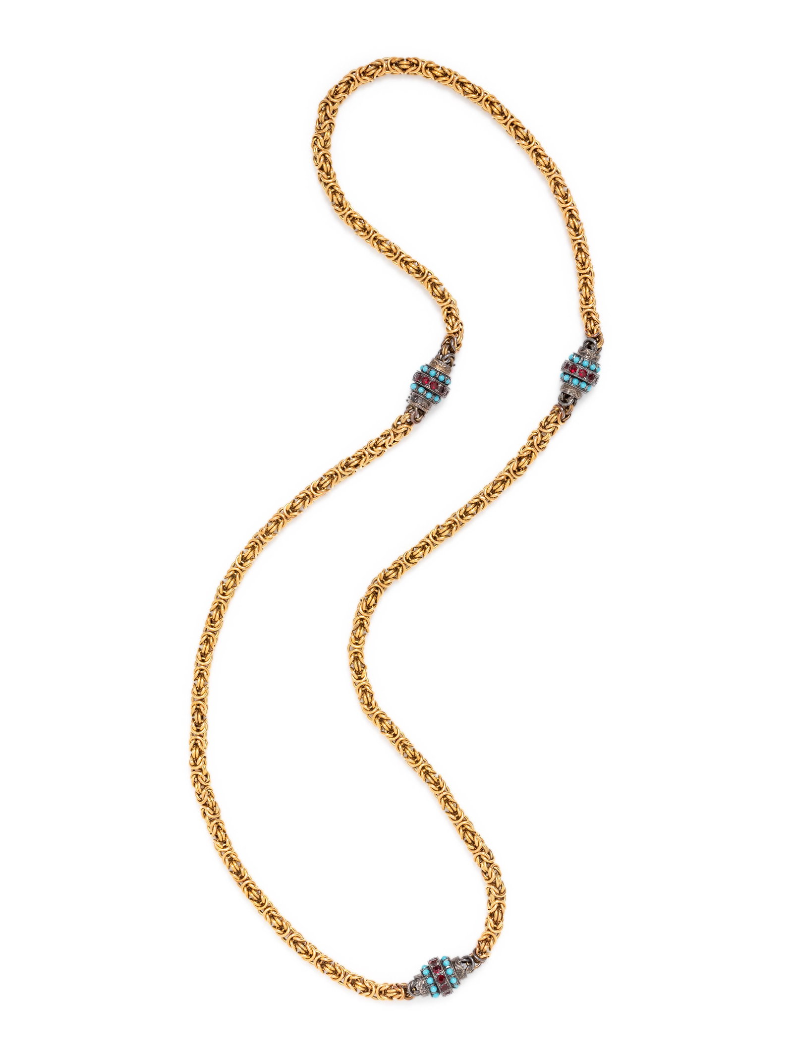YELLOW GOLD, SILVER AND GLASS NECKLACE: YELLOW GOLD, SILVER AND GLASS NECKLACE Consisting of a yellow gold Byzantine link chain interspersed with three engraved silver links containing round red glass rhinestones. Stamp: (Portuguese hallmar