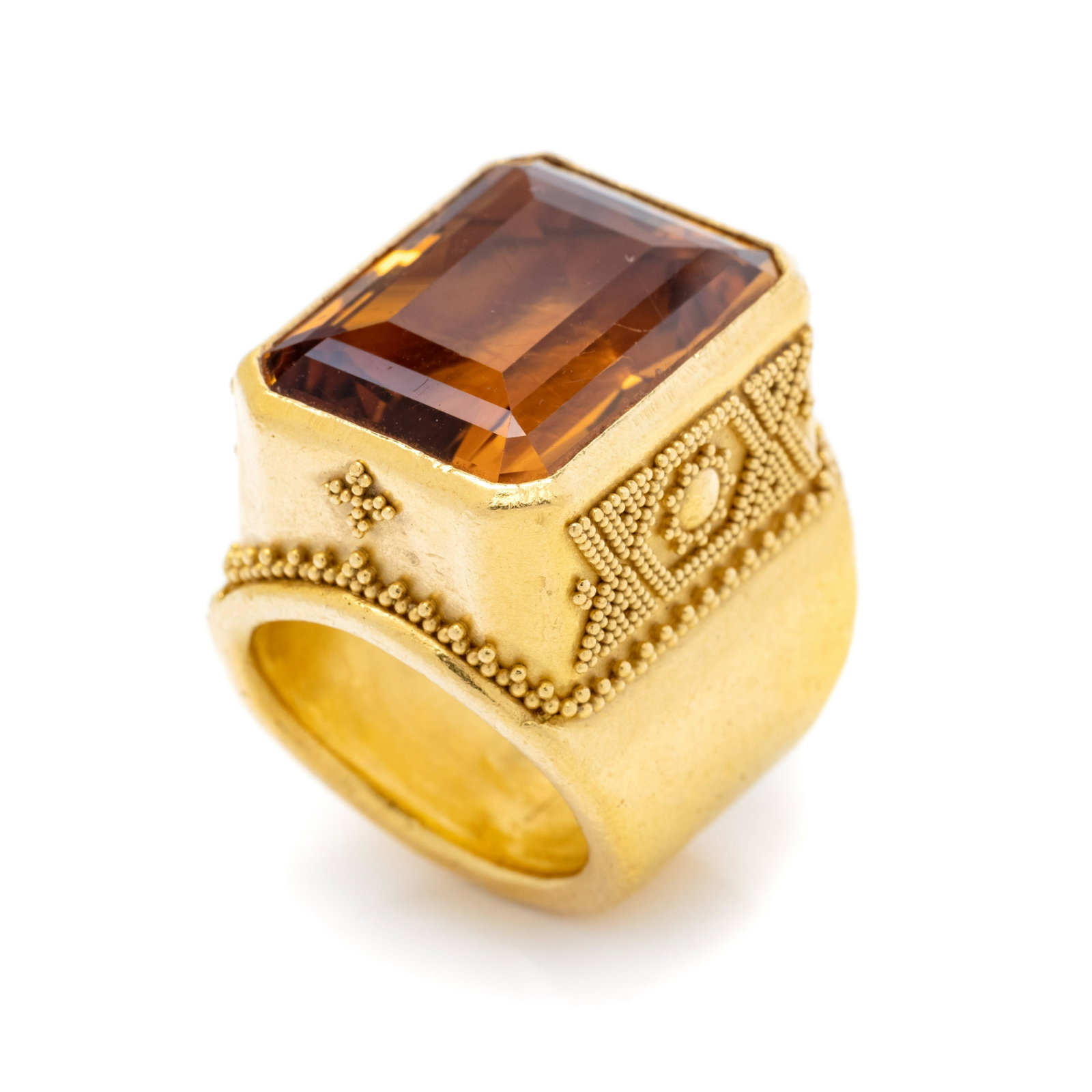 YELLOW GOLD AND CITRINE RING: YELLOW GOLD AND CITRINE RING Containing one emerald cut citrine measuring approximately 21.50 x 16.50 mm, with granulation detail. Stamp: 22K (maker's mark) 232. 28.20 dwt. Property from the Estate of