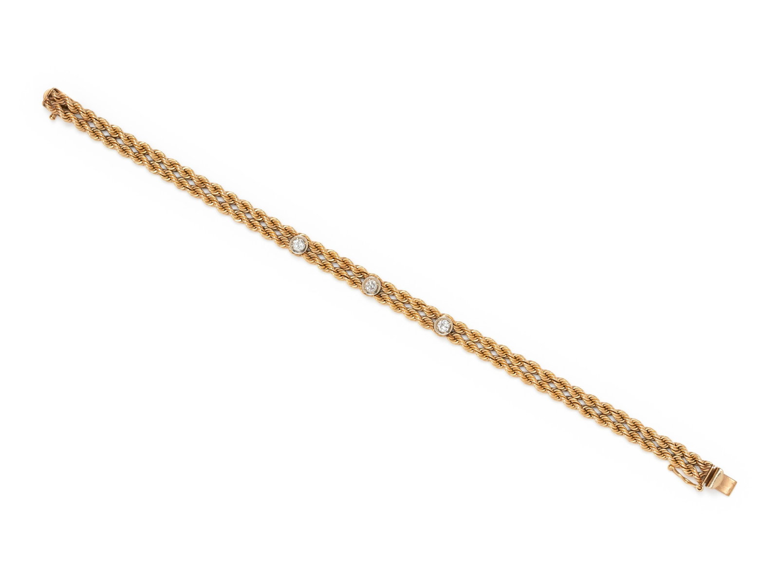 YELLOW GOLD AND DIAMOND BRACELET: YELLOW GOLD AND DIAMOND BRACELET Consisting of two attached rope chains surmounted with three round brilliant cut diamonds weighing approximately 0.20 carat total. Stamp: J 14K. 8.15 dwt. Property fro
