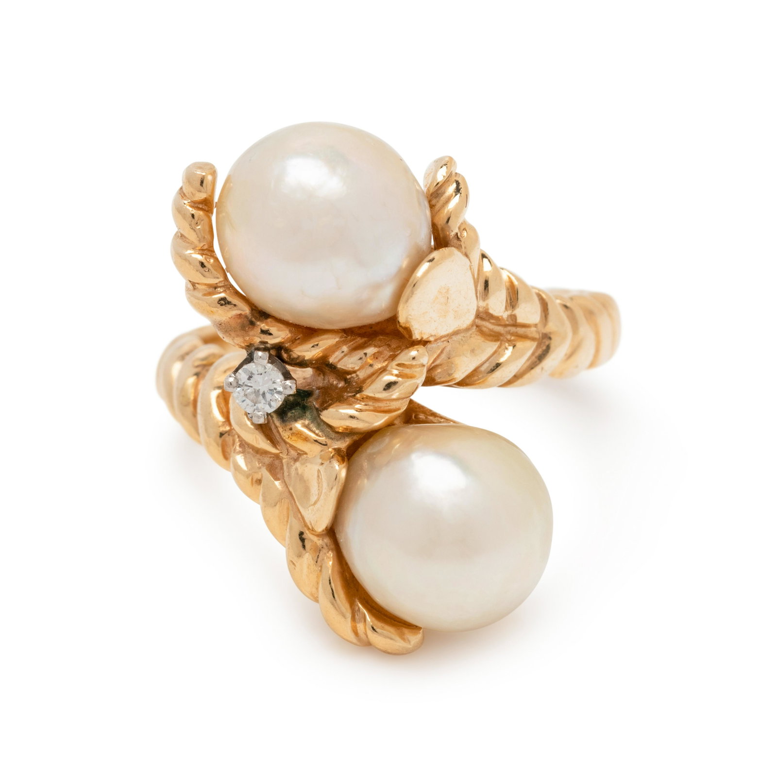 CULTURED BAROQUE PEARL AND DIAMOND RING: CULTURED BAROQUE PEARL AND DIAMOND RING In a bypass design, containing two Baroque pearls measuring approximately 9.00 mm in diameter and one round brilliant cut diamond. Mounted in yellow gold. Stamp