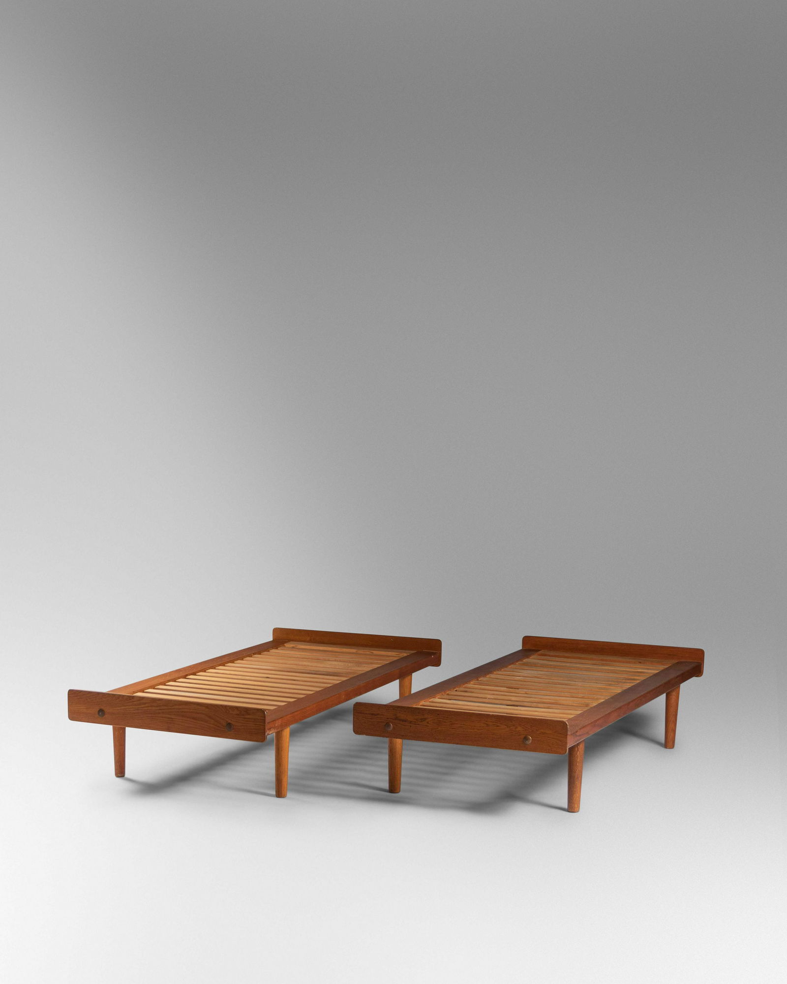 Ejvind Johansson (Danish, b. 1923) Pair of Daybeds,: Ejvind Johansson (Danish, b. 1923) Pair of Daybeds, Model G19, FDB Mobler, Denmark oak, beech, brass stamped 'FDB Made In Denmark' to underside H 14 3/4 x W 32 x D 76 inches