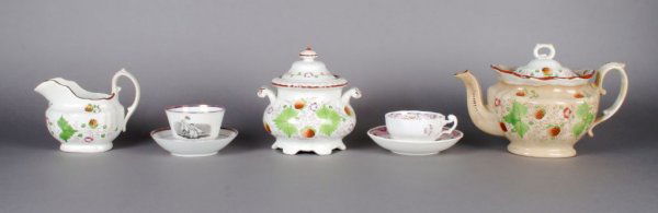 A Partial English Lusterware Tea Service, Height o: A Partial English Lusterware Tea Service, 19th century, comprising a covered teapot, a creamer, and a covered sugar, together with two associated tea cups and saucers. Height of teapot 6 1/2 inches.