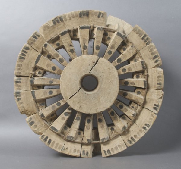 A Middle Eastern Carved Pulley Wheel, Saudi Arabia: A Middle Eastern Carved Pulley Wheel, Saudi Arabia, of multipart spoked form, retaining some of the original pigment. Diameter 18 1/2 inches.