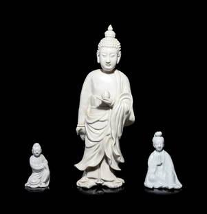 Three Chinese Blanc-de-Chine 'Dehua' Glazed Porcelain: Three Chinese Blanc-de-Chine 'Dehua' Glazed Porcelain Figures comprising two figures of seated Guanyin, and one standing Buddha. Height of tallest 30 in., 76.3 cm. Property from a Private Chicago