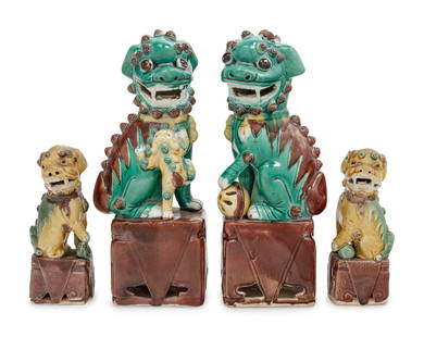 Two Pairs of Chinese Sancai Glazed Porcelain Figures: Two Pairs of Chinese Sancai Glazed Porcelain Figures of Fu Lions LATE 19TH CENTURY/EARLY 20TH CENTURY each modeled seated on a plinth, two grasping a ball, the head detailed with fierce protruding