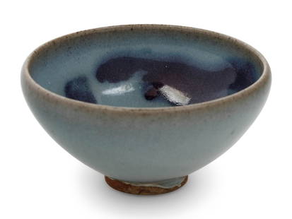 A Chinese Jun -Style Stoneware Bubble Bowl: A Chinese Jun-Style Stoneware Bubble Bowl potted with deep rounded sides rising to a slightly incurved rim, covered overall in a rich glossy lavender-blue glaze fading to a yellowish tone around the