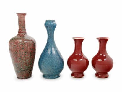 Four Chinese Monochrome Glazed Porcelain Bottle Vases: Four Chinese Monochrome Glazed Porcelain Bottle Vases comprising a pair of sang-de-boeuf glazed examples, a peachbloom glazed example and a robin's egg glazed garlic head form example. Height of