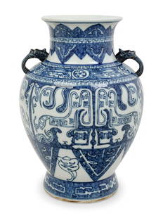 A Chinese Blue and White Porcelain Double Handled Vase: A Chinese Blue and White Porcelain Double Handled Vase of baluster form, rising from a gently spreading foot to a broad shoulder, waisted neck and a slightly lipped rim,bearing an apocryphal Kangxi si