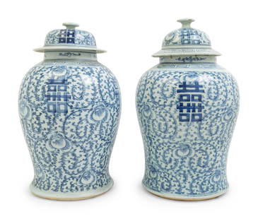 A Pair of Chinese Blue and White Porcelain Jars and: A Pair of Chinese Blue and White Porcelain Jars and Covers each of baluster form, rising from a gently spreading foot to a broad shoulder, and waisted neck, painted with lotus scrolls and xi character