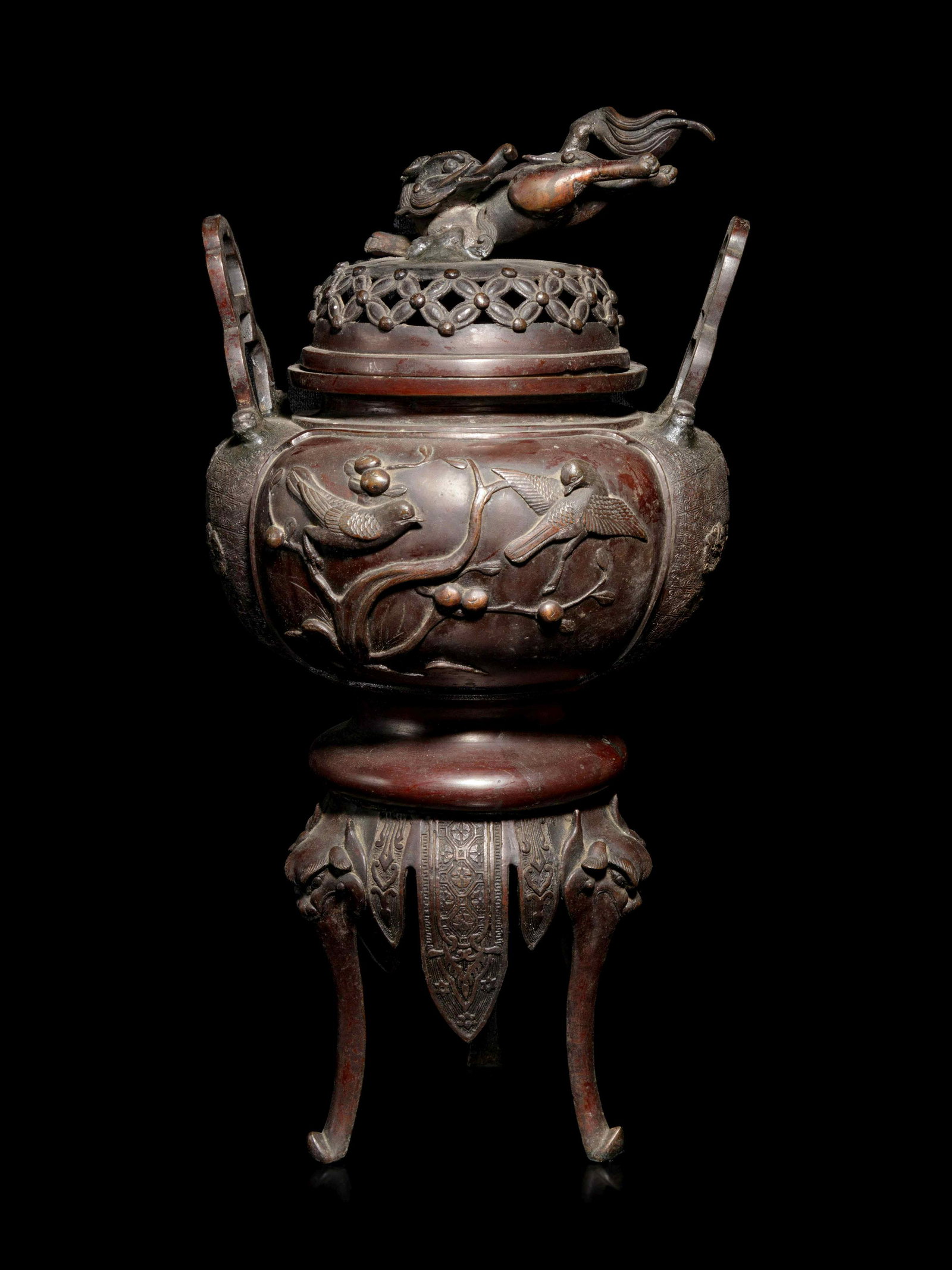 A Japanese Bronze Incense Burner: A Japanese Bronze Incense Burner LATE MEIJI PERIOD, 19TH CENTURY of globular form cast with panels enclosing birds perched on branches, set with a pair of upright shaped handles, raised on tall stand 