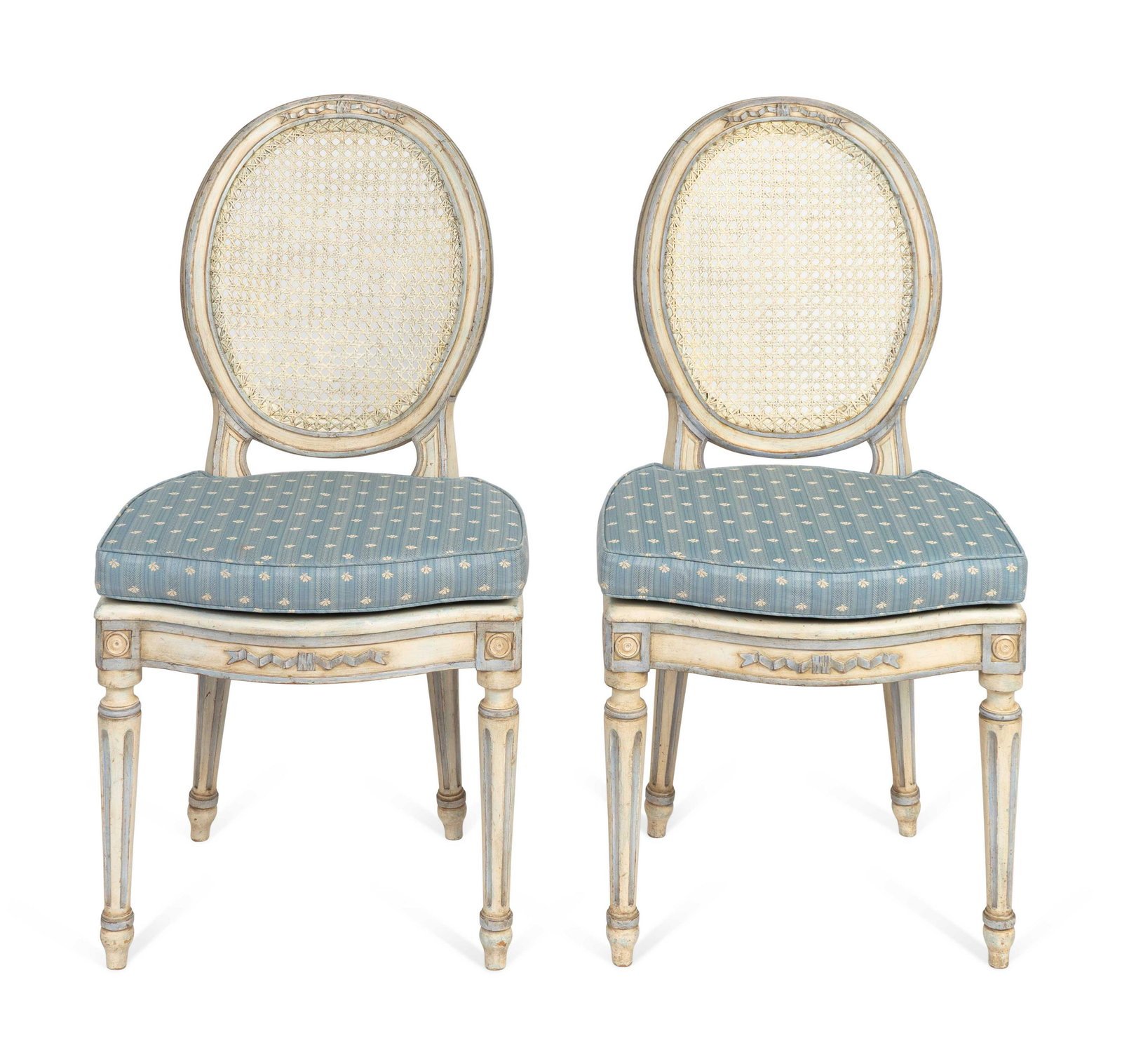A Pair of Louis XVI Style White-Painted and Caned: A Pair of Louis XVI Style White-Painted and Caned Chaises Height 38 x width 19 x depth 17 1/2 inches. Provenance: Doyle's New York, September 10, 2013. Property from a Michael Simon Designed Interior,