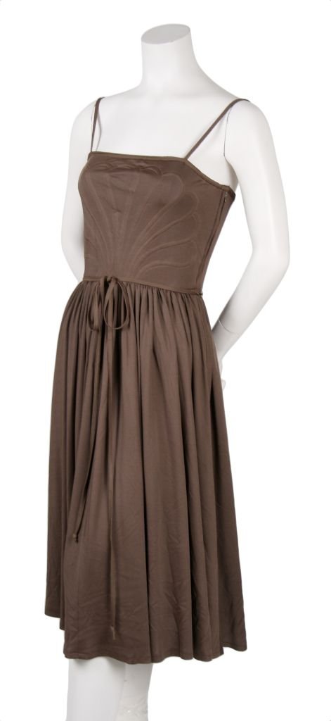 A Donald Brooks Brown Jersey Dress, Size 8.: A Donald Brooks Brown Jersey Dress, 1970s, with a fitted bodice and decorative stitching, skinny belt, and gathered waistline. Labeled: Donald Brooks. Size 8.