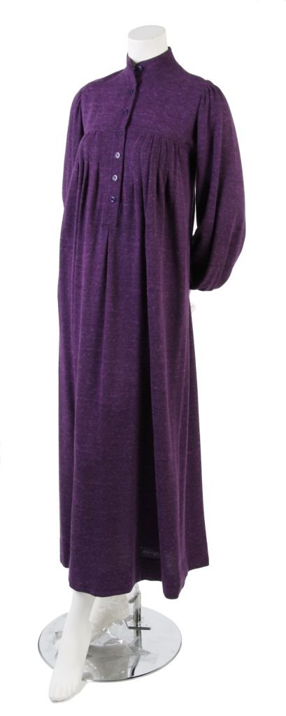 An Yves Saint Laurent Knit Dress, Size 36.: An Yves Saint Laurent Knit Dress, 1970s, in purple wool, with long sleeves gathered at cuff and shoulder, band collar, gathers below front and back yoke, full length. Labeled: Saint Laurent Rive Gauch