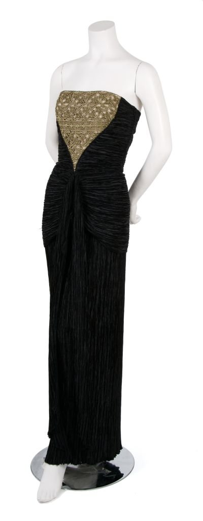 A Mary McFadden Black Pleated Silk Gown,: A Mary McFadden Black Pleated Silk Gown, 1980s, with boned and fitted bodice, thin straps, bronze lace inset at center front. Labeled: Mary McFadden/Couture.