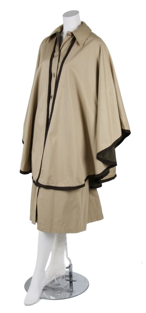 An Yves Saint Laurent Khaki Twill Raincoat,: An Yves Saint Laurent Khaki Twill Raincoat, with brown trim, spread collar, attached cape, fully lined. Labeled: Saint Laurent/Rive Gauche.
